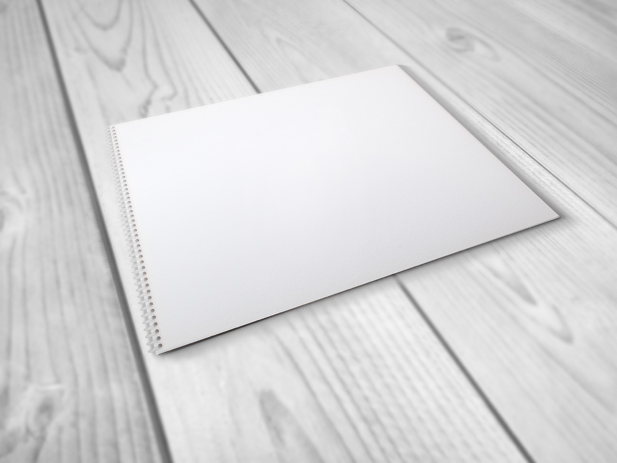laptop and notebook on wooden table